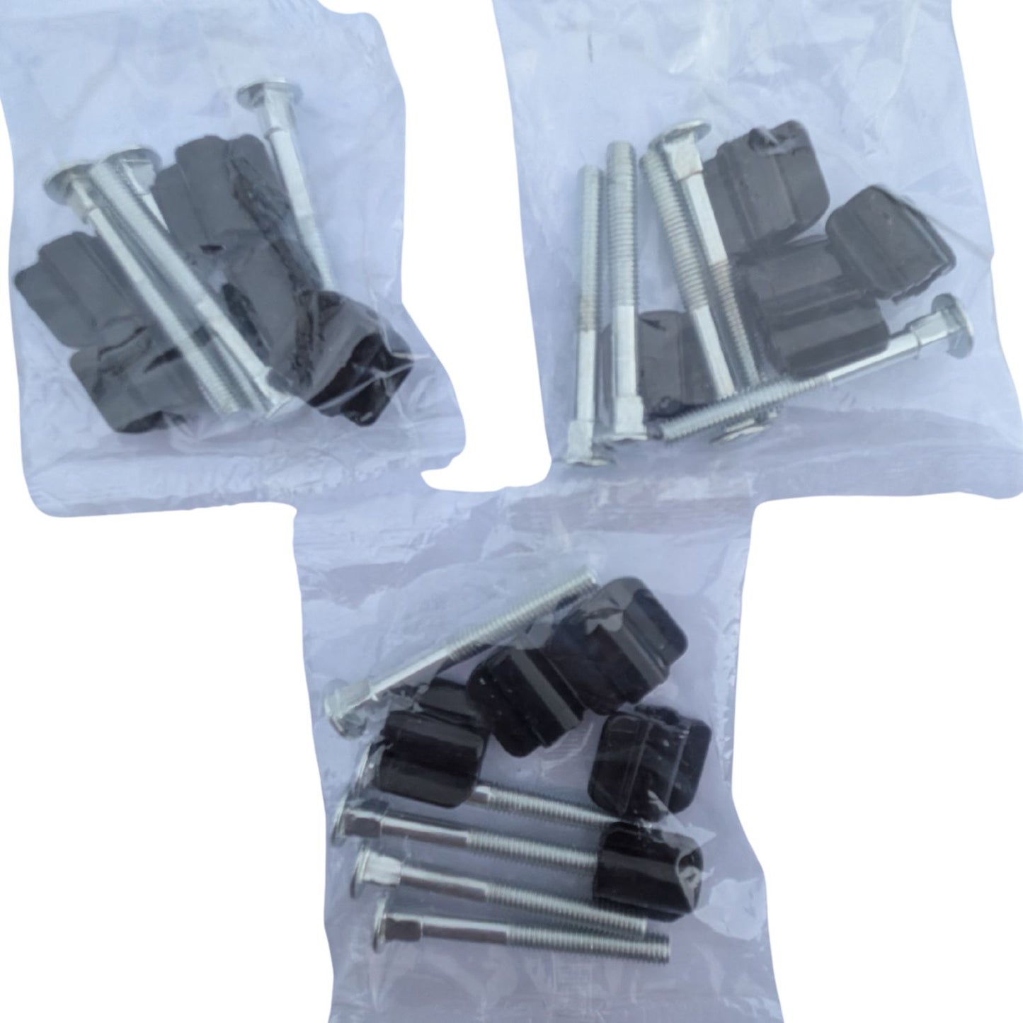 Set of screws and plastic components in clear bags on a white background