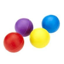 Four colorful dog toy balls in red, yellow, purple, and blue on a white background