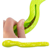 Hand holding a green snake dog toy, showing how to open channel to put treats in