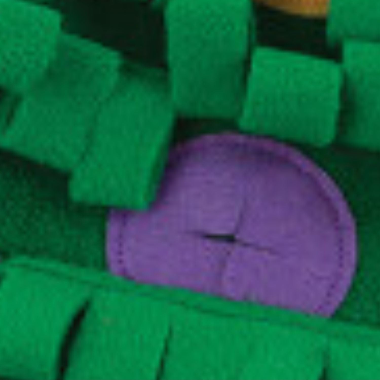 Close-up of green textured fabric with a purple heart shape