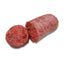 Sliced raw dog food sausage on a white background
