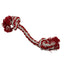 Red and white rope dog toy with pom-poms on a white background
