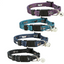 Four cat collars in different colors with bell charms on a white background