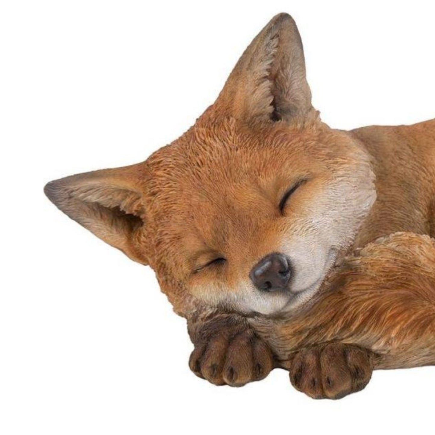 Sleeping fox figurine on a white background