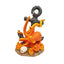 An underwater-themed decorative figurine featuring a bright orange octopus wrapped around a dark anchor, set on a sandy base with a small white shell, isolated on a white background.