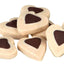 Heart-shaped dog treats with chocolate coloured centers on a white background