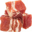 Cubes of marbled red meat dog treats on a white background
