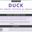 Dog food label for duck with sweet potato and orange, featuring text and a duck illustration.