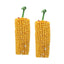 Two corn-shaped small animal treats  with green handles on a white background