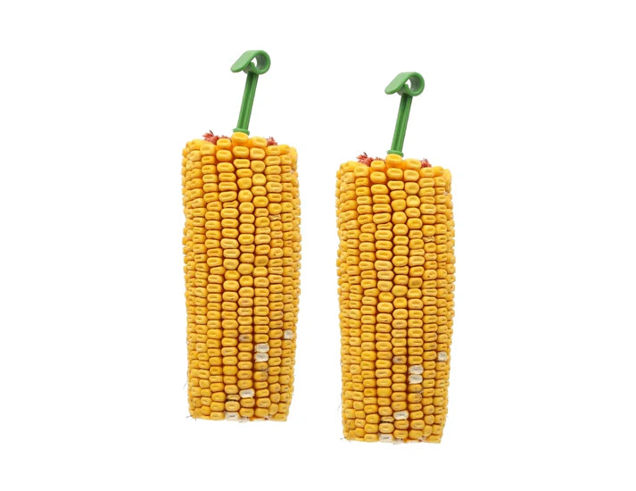 Two corn-shaped small animal treats  with green handles on a white background