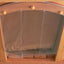 Plastic flaps attached to the door of a wooden dog kennel.