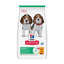 A bag of Hill's Science Plan Puppy <1 dog food on a plain white background. The white bag features a green top band, a photo of two beagle puppies wearing red collars, the Hill's Science Plan logo, and a green and white nutrition panel at the bottom.