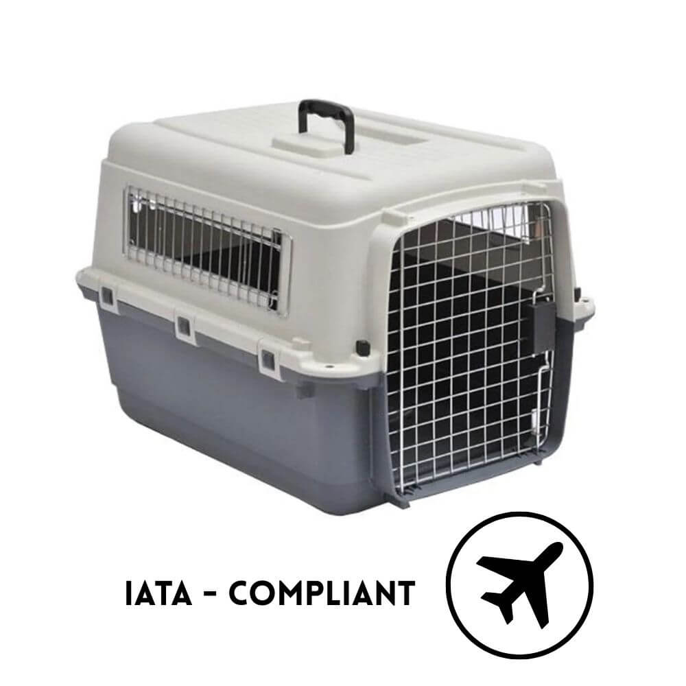A pet aviation carrier crate with a light gray top and dark gray base, featuring metal wire ventilation grates and a front door. The image includes the text 'IATA - COMPLIANT' and an airplane icon at the bottom right. Suitable for dogs and cats.