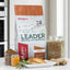 Red Mills Leader natural dog nutrition package on a kitchen counter with food items.