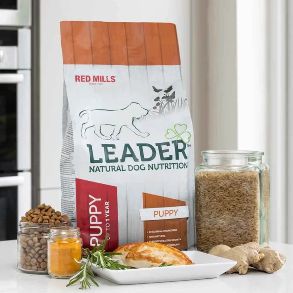 Red Mills Leader natural dog nutrition package on a kitchen counter with food items.