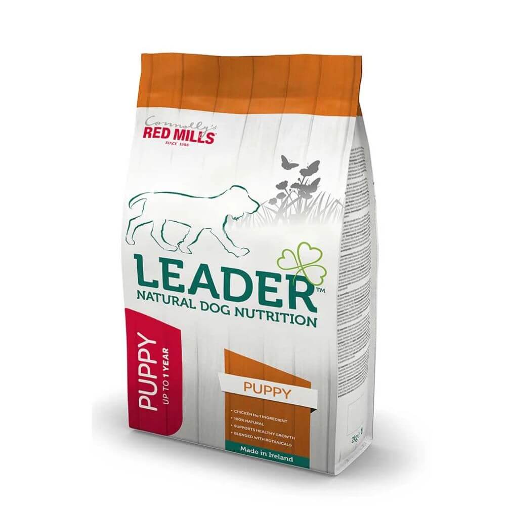 A bag of Red Mills Leader Natural Dog Nutrition Puppy dog food, featuring a white bag with an orange top, green text, and a red 'PUPPY' label, shown on a white background.
