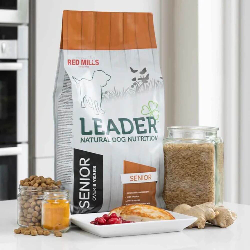 Red Mills Leader natural dog nutrition package on a kitchen counter with ingredients.