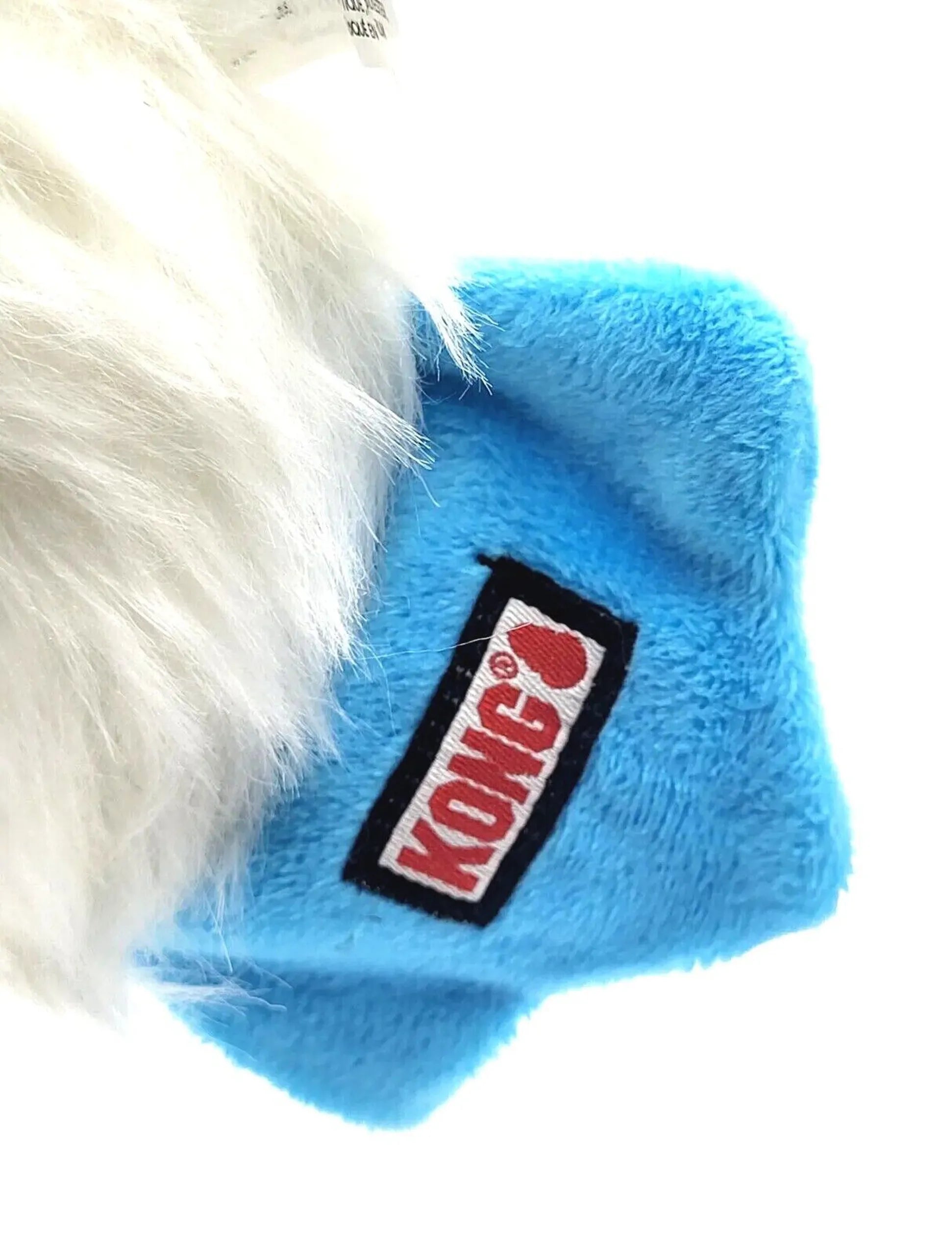 Blue KONG dog toy with a white dog chewing on it