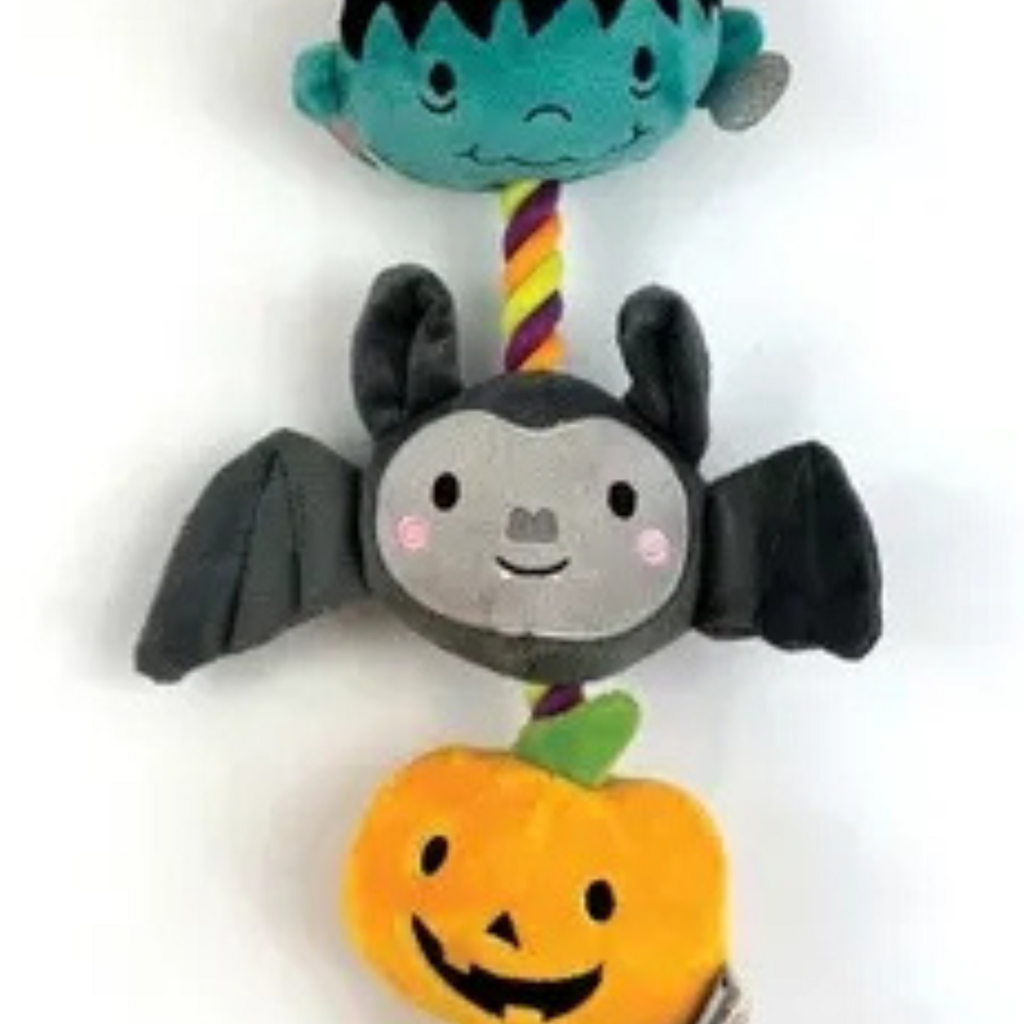Plush dog  toy with a bat, Frankenstein, and pumpkin on a white background