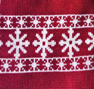 Close-up of a red fabric with white snowflake pattern