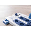 Blue and white puzzle dog toy on a light wooden surface