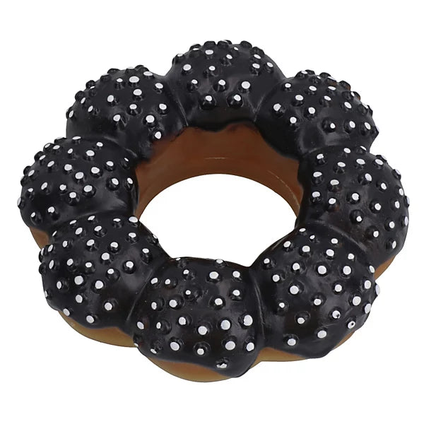 Black donut dog toy with white spikes on a white background