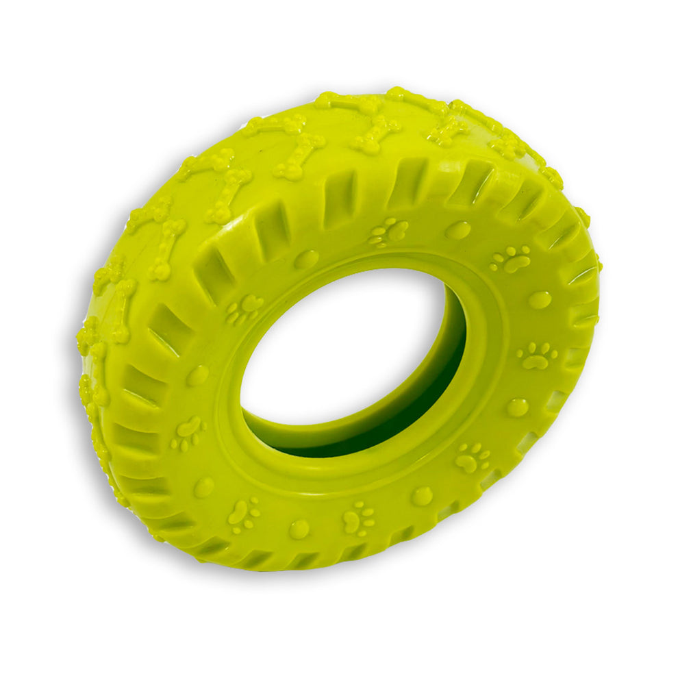 Green rubber tire toy with paw print patterns on a white background