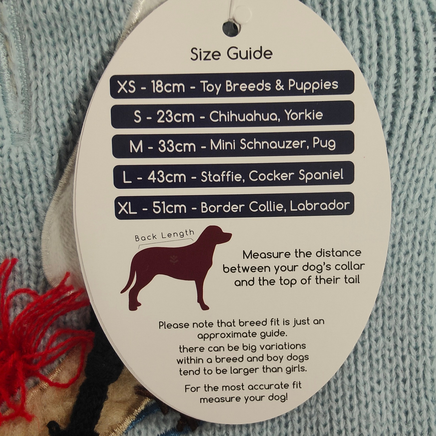Size guide for dog clothing on a textured fabric background