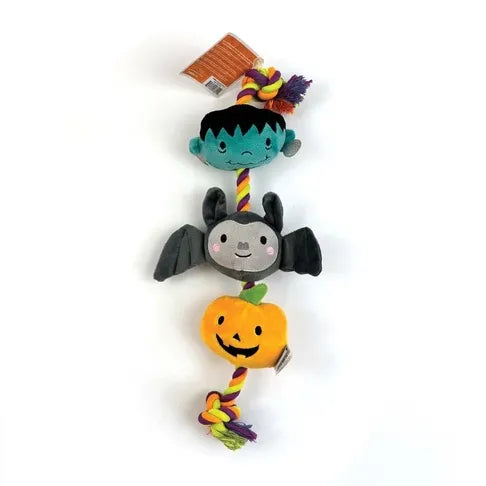 Halloween-themed plush dog toy with a bat, pumpkin, and ghost design on a white background