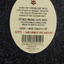 Label on a dark fabric background with text and a barcode