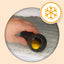Hand holding a black rubber dog toy with snowflake icon indicating cold temperature