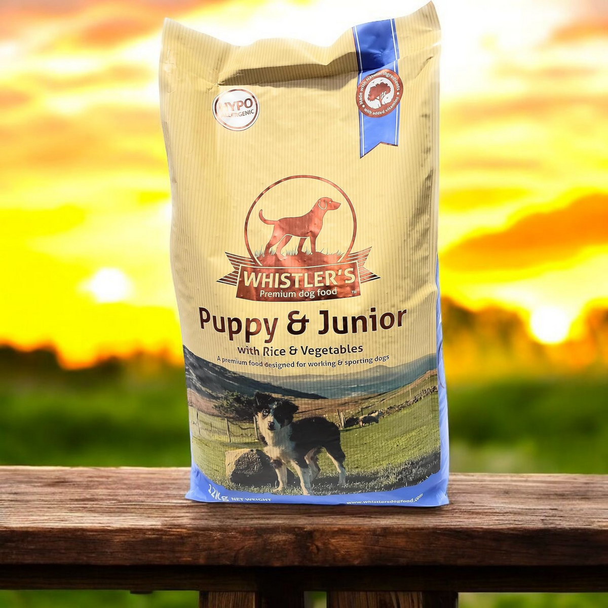 Bag of Whistler's Puppy & Junior dog food with a sunset background