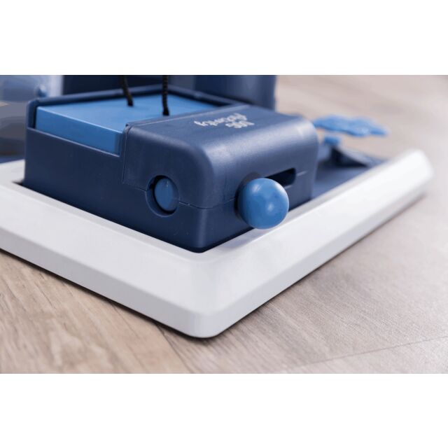 Part of a dog interactive puzzle on a wooden floor