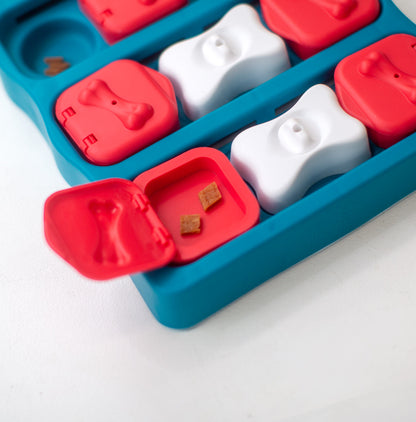 Dog puzzle toy with red and white shapes on a white background