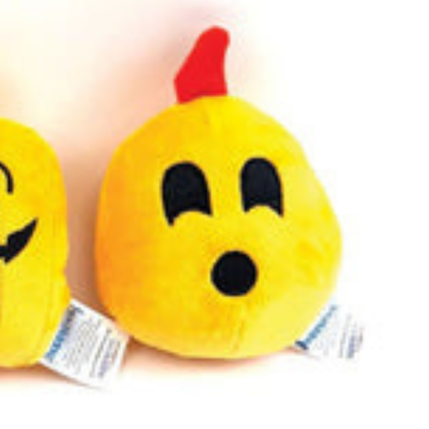 Plush dog toy with a surprised face expression on a white background