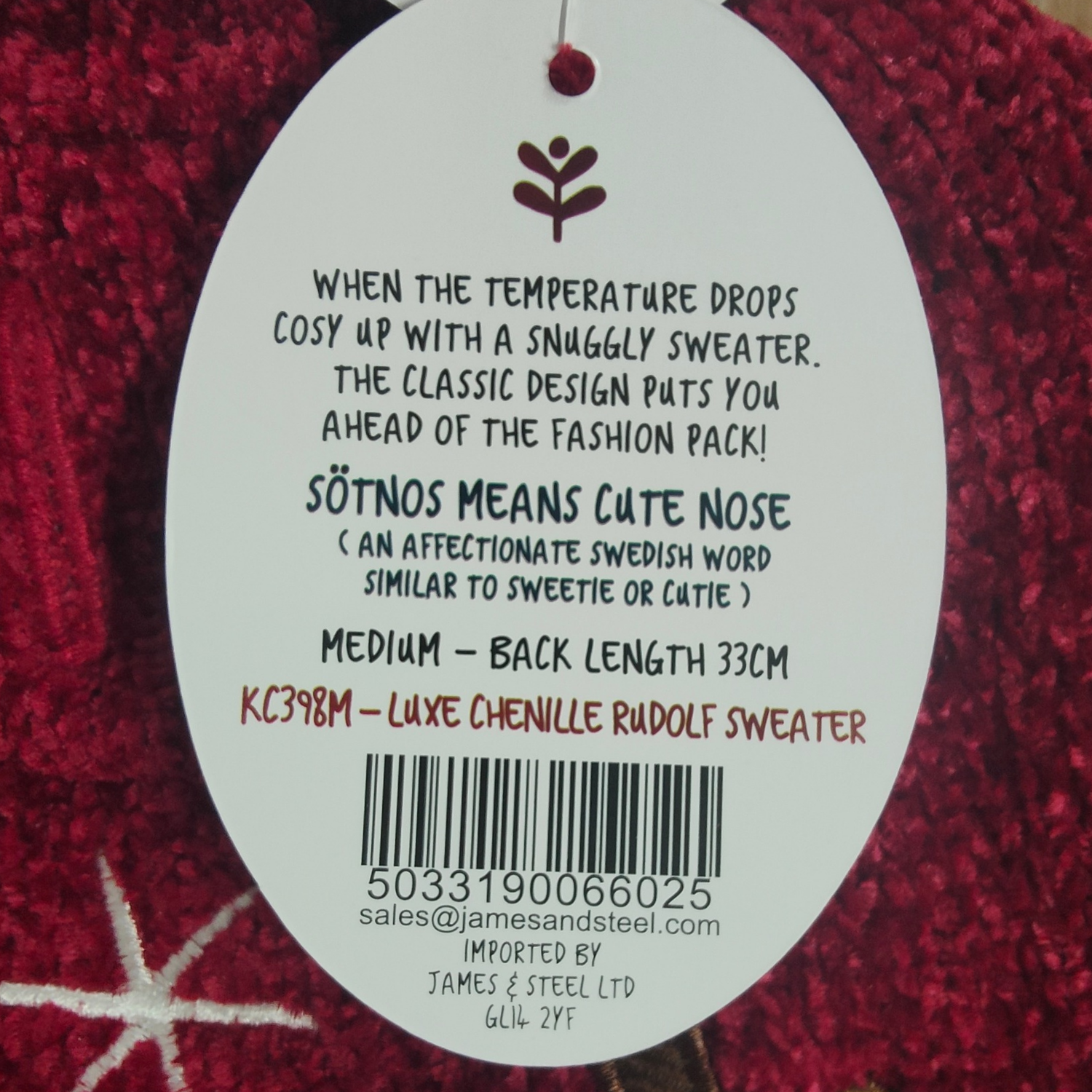 Label on a red sweater with text and a barcode