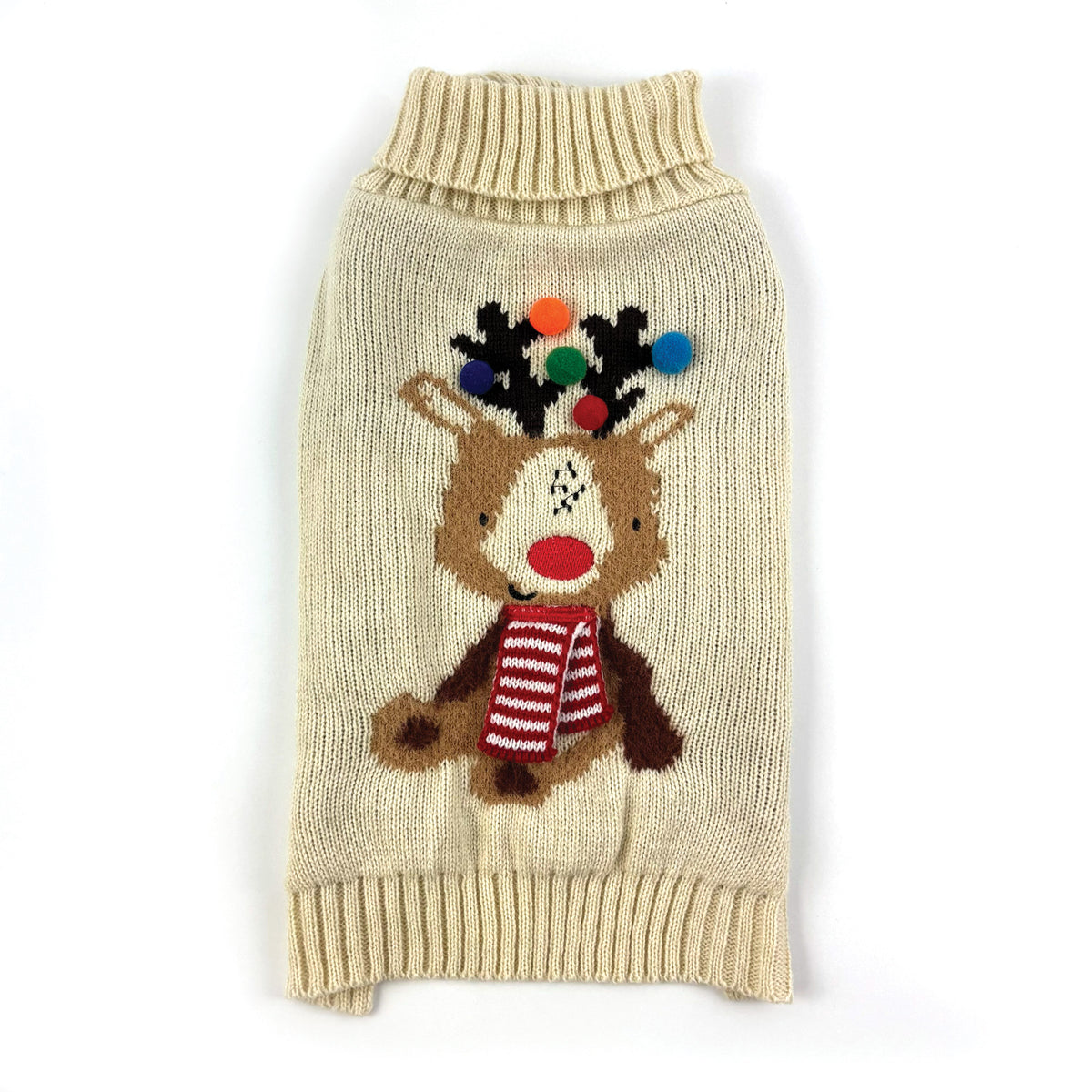 A cream-colored knit pet sweater featuring a knitted reindeer design with a red and white striped scarf and colorful pom-pom antlers, shown on a plain white background.