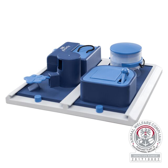 Blue and gray dog interactive puzzle with various components on a white background, featuring an Animal Welfare Compliance logo.