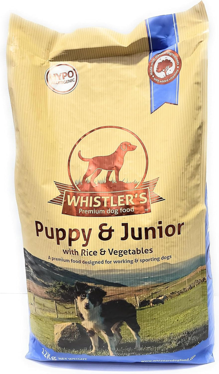 Whistler's Puppy & Junior dog food bag with images of dogs and a scenic background.