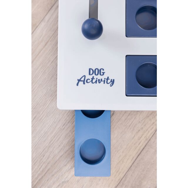 Dog activity toy with blue and white design on a wooden surface