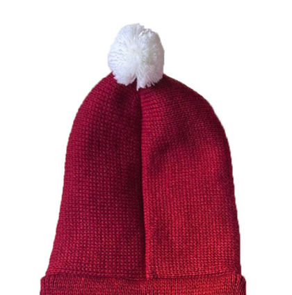 Red knit beanie with a white pom-pom on a white background