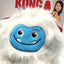White plush dog toy with blue face and KONG branding on packaging