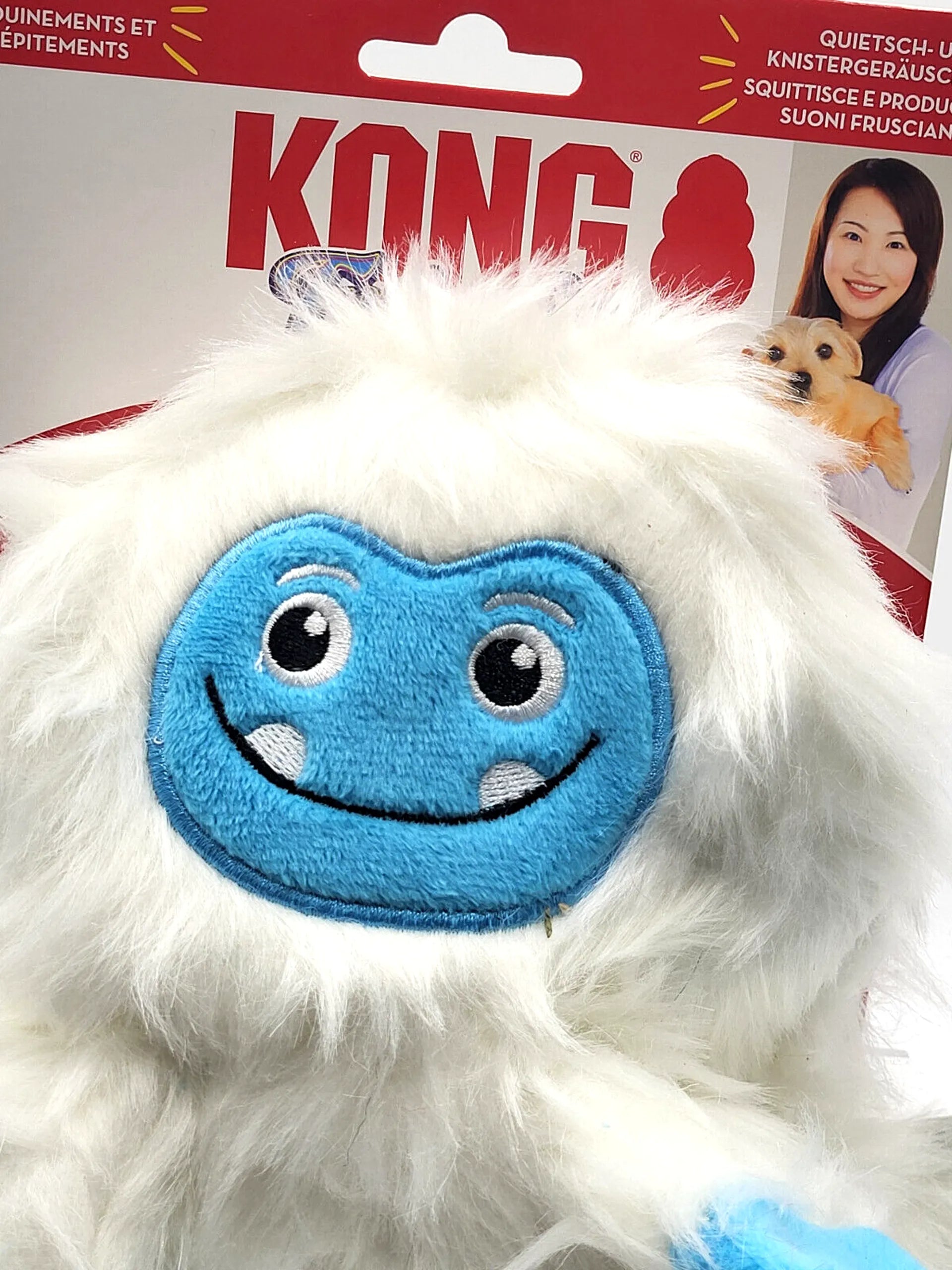 White plush dog toy with blue face and KONG branding on packaging