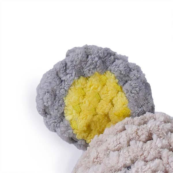 Gray and yellow ear of dog toy on a white background