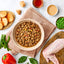 Bowl of cooked meat dish with ingredients on a table