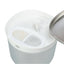 A close-up of a white and light gray pet waterer or feeder container with a stainless steel lid partially visible on the right. The top has a central white spout and two oval filter compartments, one showing a beige filter and the other a gray filter. It is a dog water bowl with fountain, stainless steel bowl, filters and clear container. 