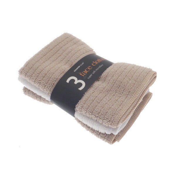 Set of three beige face cloths with a label on a white background