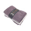 Pack of three purple face cloths with a visible brand label on a white background